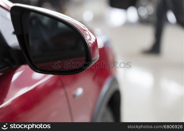 rear side mirror of new red car, selective focus