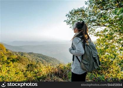 Rear view back of Young asian hiking female standing at view point and looking beautiful view with happy on peak mountain and sunray,  copy space