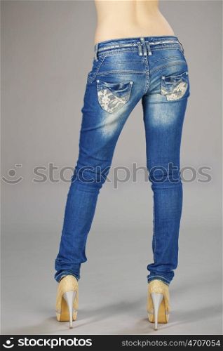 Rear view, female denim pants, isolated on gray background