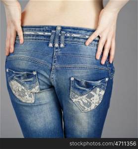 Rear view, female denim pants, isolated on gray background
