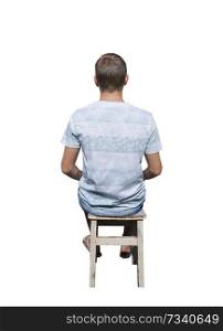 Rear view full length portrait of pensive young man sitting on a old chair and meditate isolated over white background.