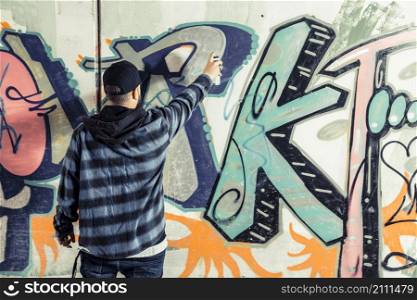 rear view man making graffiti wall