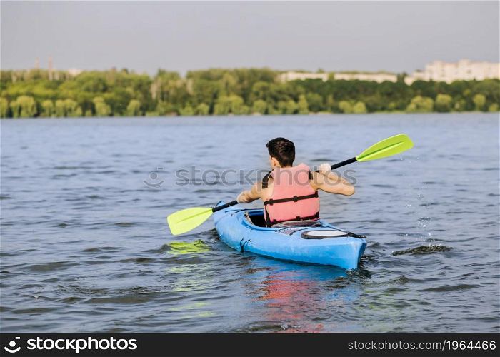 rear view man using paddle kayaking. High resolution photo. rear view man using paddle kayaking. High quality photo
