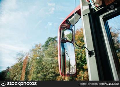 rear-view mirror in the bus riding the european roads of Europe