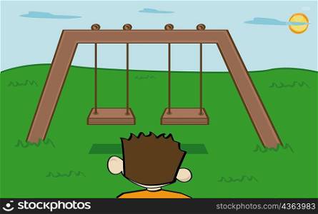 Rear view of a boy standing in a playground