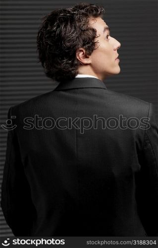 Rear view of a businessman looking up and thinking