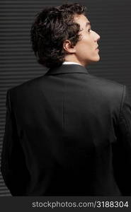 Rear view of a businessman looking up and thinking