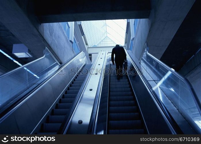 Rear view of a businessman on an escalator