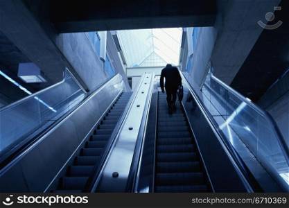 Rear view of a businessman on an escalator