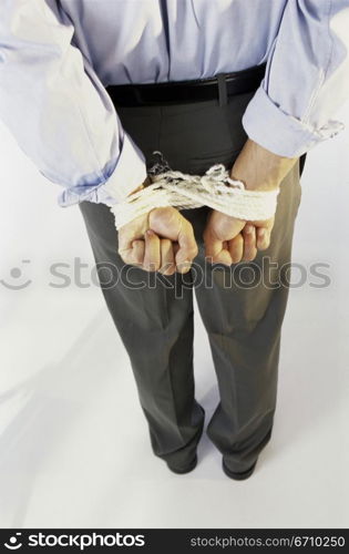 Rear view of a businessman with his hands tied behind his back