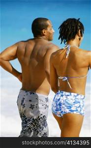 Rear view of a couple in swimsuit, Horse-shoe Bay beach, Bermuda