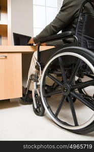 Rear view of a disabled man in a wheelchair