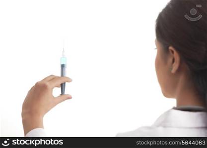 Rear view of a female doctor holding syringe isolated over white background