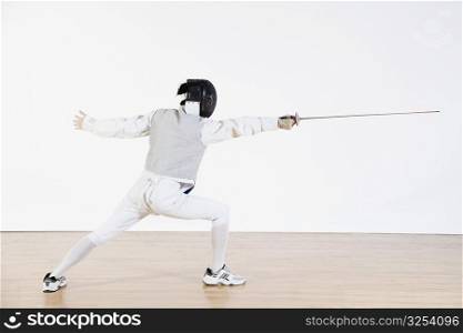 Rear view of a fencer practicing fencing