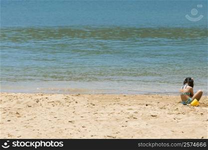 Rear view of a girl playing on the beach, Nawiliwili Beach Park, Kauai, Hawaii Islands, USA