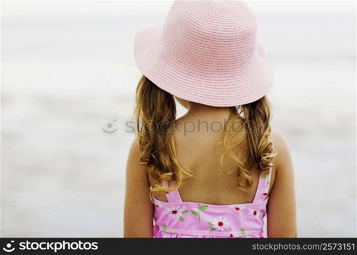 Rear view of a girl standing on the beach