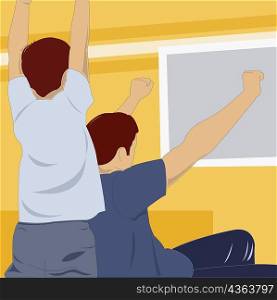 Rear view of a man and a boy cheering