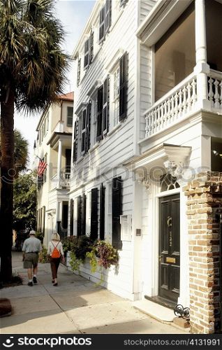 Rear view of a man and a woman walking on the street, Charleston, South Carolina, USA