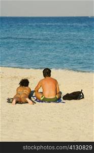 Rear view of a man and woman on the beach