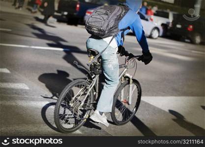 Rear view of a man cycling