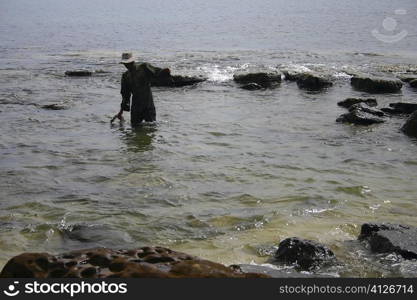 Rear view of a man fishing, Sihanoukville, Cambodia