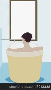 Rear view of a man in a bathtub