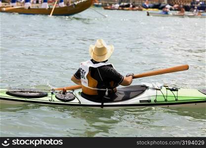Rear view of a man kayaking, Venice, Veneto, Italy