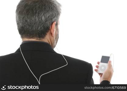 Rear view of a man listening to an MP3 player