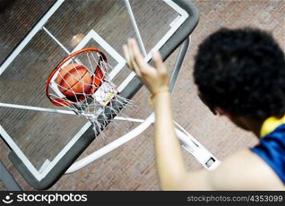 Rear view of a man playing basketball