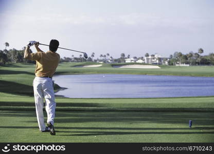 Rear view of a man playing golf