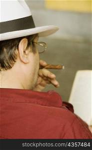 Rear view of a man smoking a cigar, Piazza Colombo, Mercato Orientale, Genoa, Italy