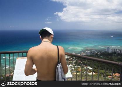 Rear view of a man standing at an observation point, Diamond Head, Waikiki Beach, Honolulu, Oahu, Hawaii Islands, USA