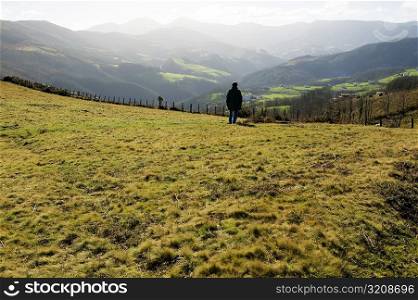 Rear view of a man standing on a hillside, Spain