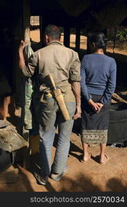 Rear view of a man standing with a woman, Phonsavan, Laos