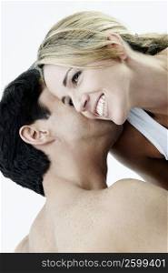 Rear view of a mid adult man kissing a mid adult woman