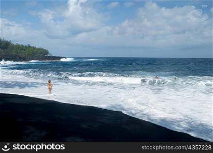 Rear view of a naked woman standing on the beach, Kehena Beach, Big Island, Hawaii Islands, USA