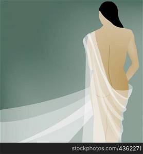 Rear view of a naked young woman draped in cloth