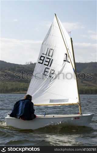 Rear view of a person participating in a sailboat race
