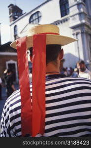 Rear view of a person wearing a straw boater hat, Italy