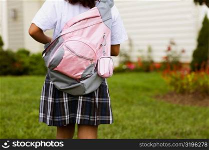 Rear view of a schoolgirl carrying a schoolbag