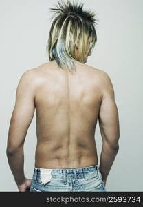 Rear view of a semi-dressed young man