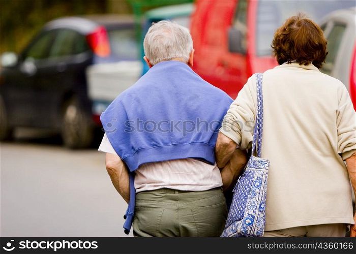 Rear view of a senior couple walking with arm in arm, Corniglia, Italian Riviera, Cinque Terre National Park, Vernazza, La Spezia, Liguria, Italy