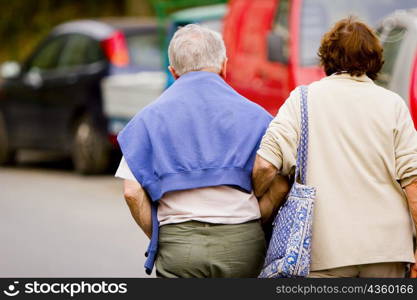 Rear view of a senior couple walking with arm in arm, Corniglia, Italian Riviera, Cinque Terre National Park, Vernazza, La Spezia, Liguria, Italy