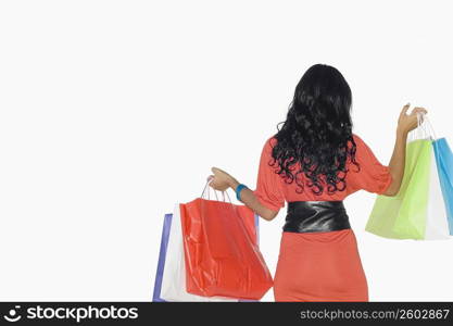 Rear view of a teenage girl holding shopping bags