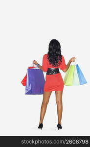 Rear view of a teenage girl holding shopping bags