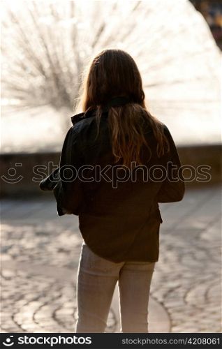 Rear view of a teenage girl looking at fountain, National Theatre, Oslo, Norway