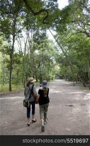 Rear view of a woman and her daughter walking on the road, Copan, Copan Ruinas, Copan Department, Honduras