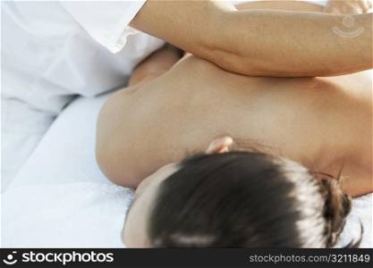 Rear view of a woman getting a back massage