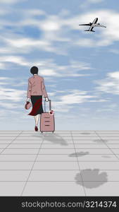 Rear view of a woman pulling a suitcase
