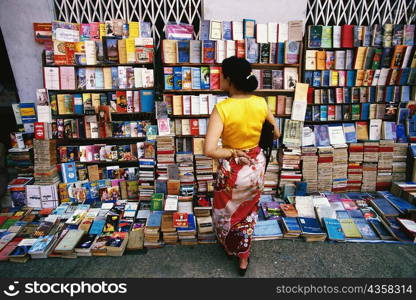 Rear view of a woman standing at bookstall, Yangon, Myanmar